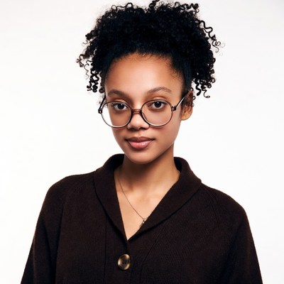 African-American woman with curly hair and glasses