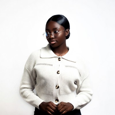 African-American woman in white cardigan