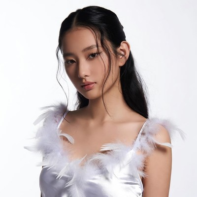Asian woman in feathered white dress