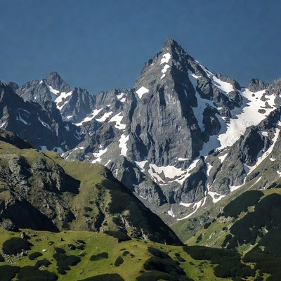 Snowy Mountain Peak with Green Slopes