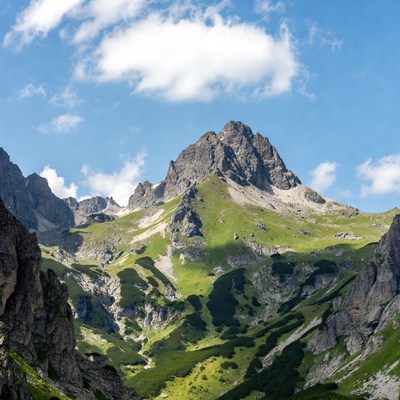 Majestic Mountain Peak with Green Slopes