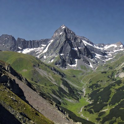 Snow-capped mountain peak with green valley