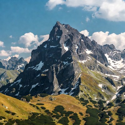 Majestic Mountain Peak with Snow and Alpine Meadows