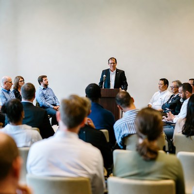 Man speaking at business meeting podium
