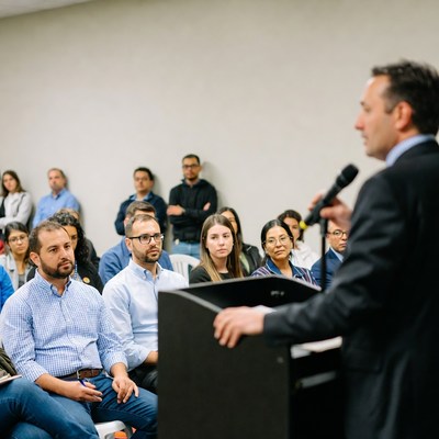 Man speaking at podium to audience