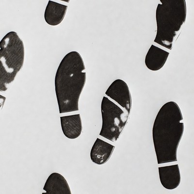 Black shoe prints on white background