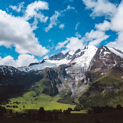 Snowy Mountain Peaks in Green Valley