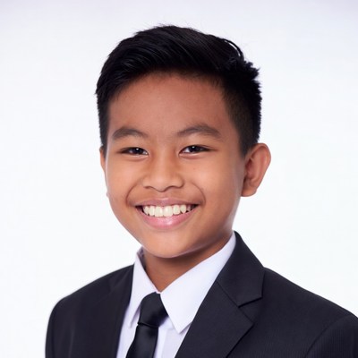Asian boy smiling in black suit