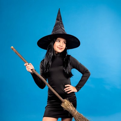 Girl in witch costume holding broom