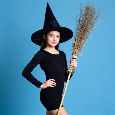 Girl in witch costume with broom