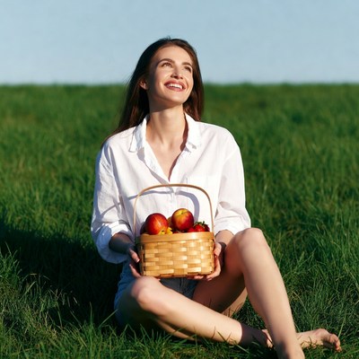 Woman holding basket of apples