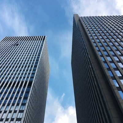 Two Tall Skyscrapers Against Blue Sky