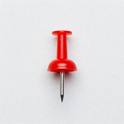 Red push pin on white
