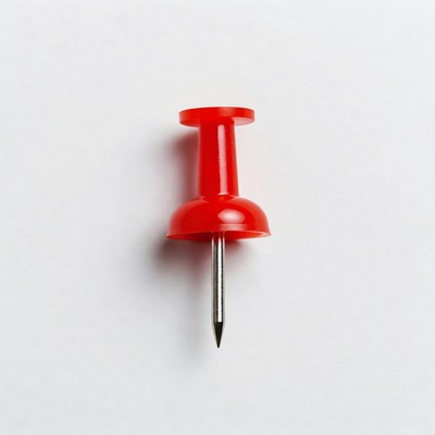 Red push pin on white background