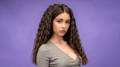 Woman with curly hair on purple background