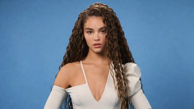 Woman with curly hair in white dress
