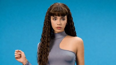 Woman with curly hair on blue background