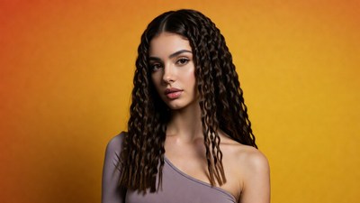 Woman with curly hair on orange background