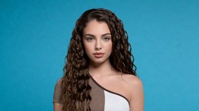 Young woman with curly hair on blue background