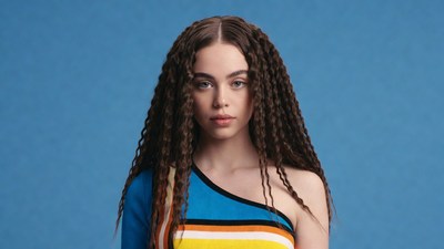 Woman with curly hair in colorful top