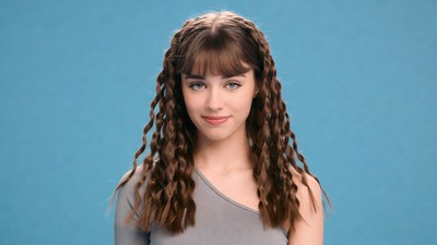 Teen girl with curly bangs smiling