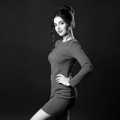 Beautiful woman in black dress posing