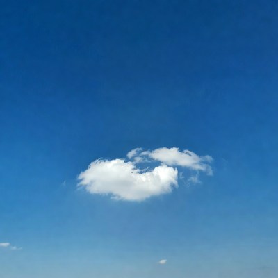 Fluffy Heart-Shaped Cloud in Blue Sky