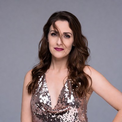 Woman in sequin dress on gray background