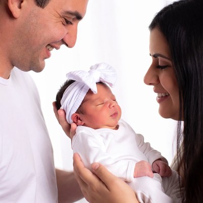Parents smiling at newborn baby