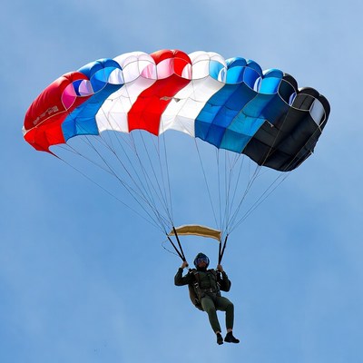 Skydiver parachuting with colorful parachute