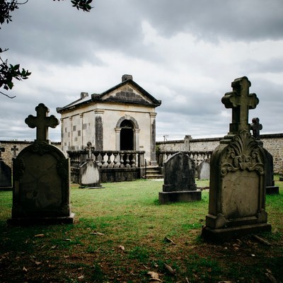 Old Mausoleum in Cemetery with Crosses