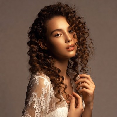 Woman with curly hair in lace top