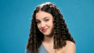 Teen girl with curly hair smiling