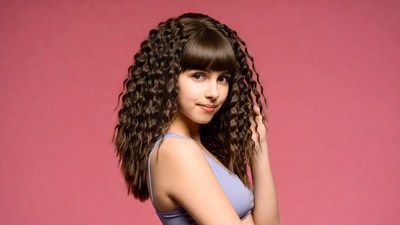 Girl with curly bangs on pink background