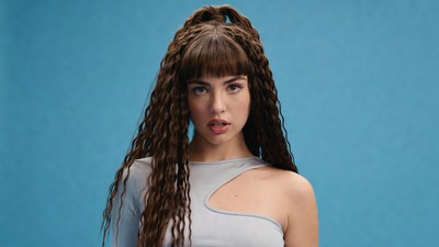 Woman with curly bangs on blue background