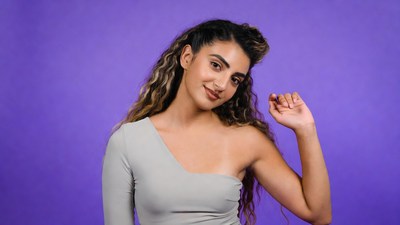 Woman waving on purple background