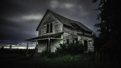 Abandoned haunted house in stormy woods