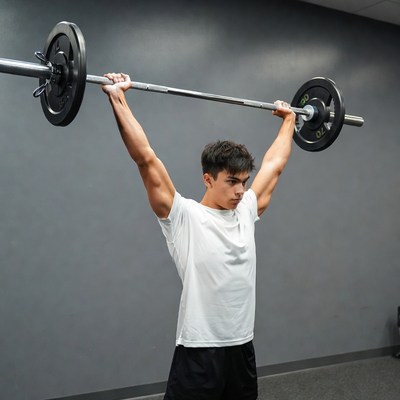 Young man overhead barbell lift