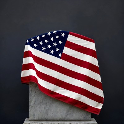American Flag Draped on Stone Pedestal