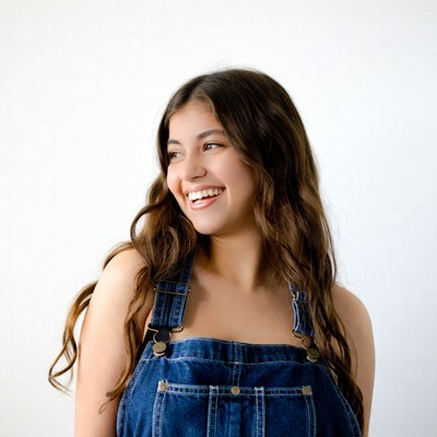 Smiling woman in denim overalls