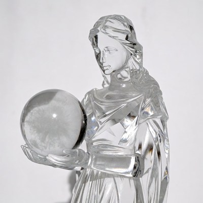 Crystal woman statue holding crystal ball