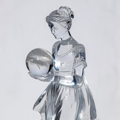 Crystal woman holding glass orb