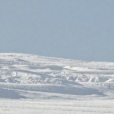Snowy Hills Under Blue Sky