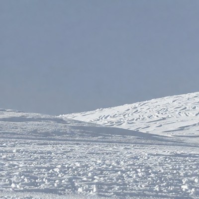 Snowy Hills Under Blue Sky