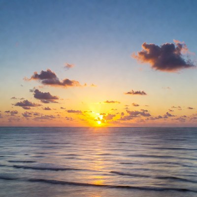 Sunrise over calm ocean waves