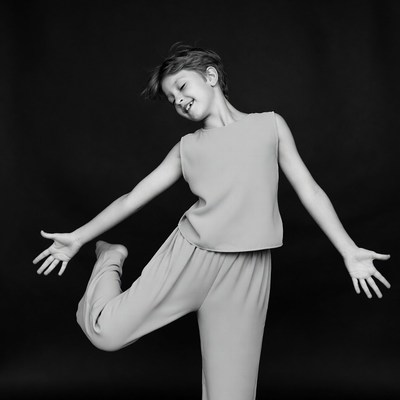 Boy dancing with arms outstretched