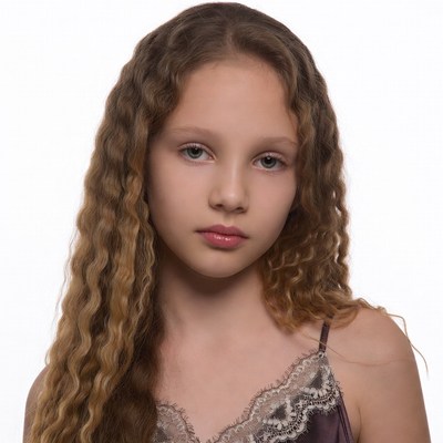 Girl with curly hair in lace slip