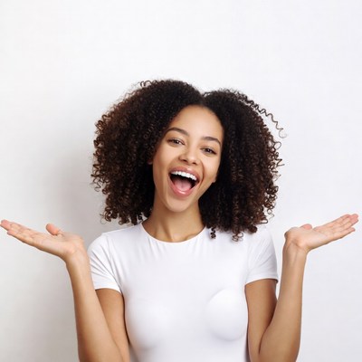 African-American woman laughing with arms raised