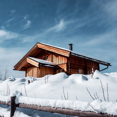 Wooden chalet covered in snow