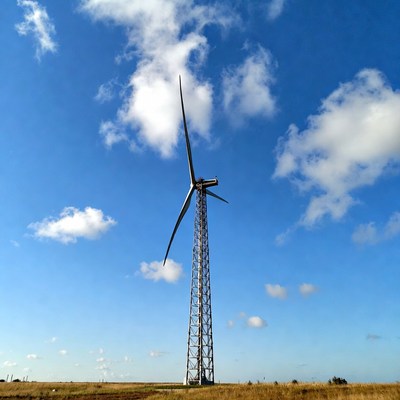 Wind turbine in grassy field